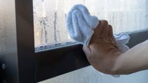 Wiping away Condensation. How to stop condensation on windows, doors and conservatories.